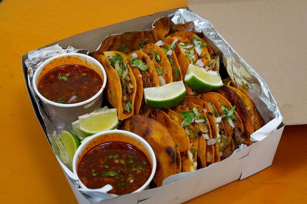 box of Birria tacos with consomme