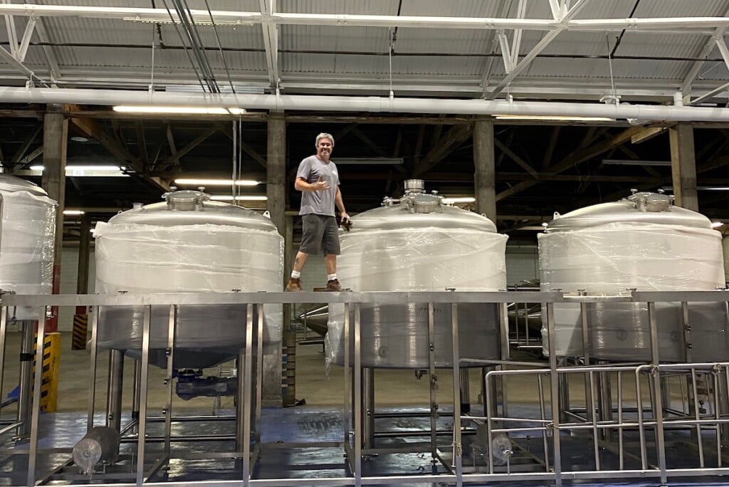 geoff seideman atop tanks at Honolulu Beerworks Kapalama Facility