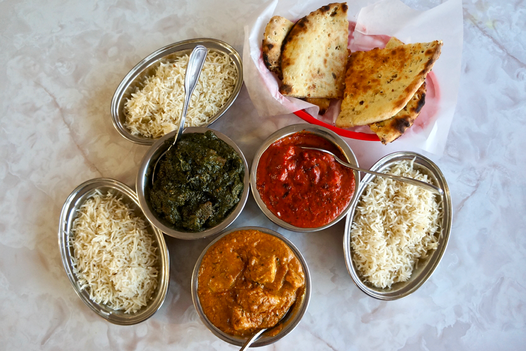 assorted indian curries and naan