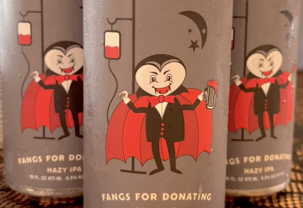 beer can with cartoon of vampire giving blood